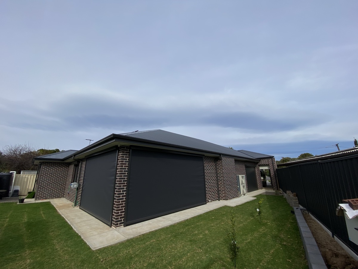 Dark outdoor blinds brick house wide