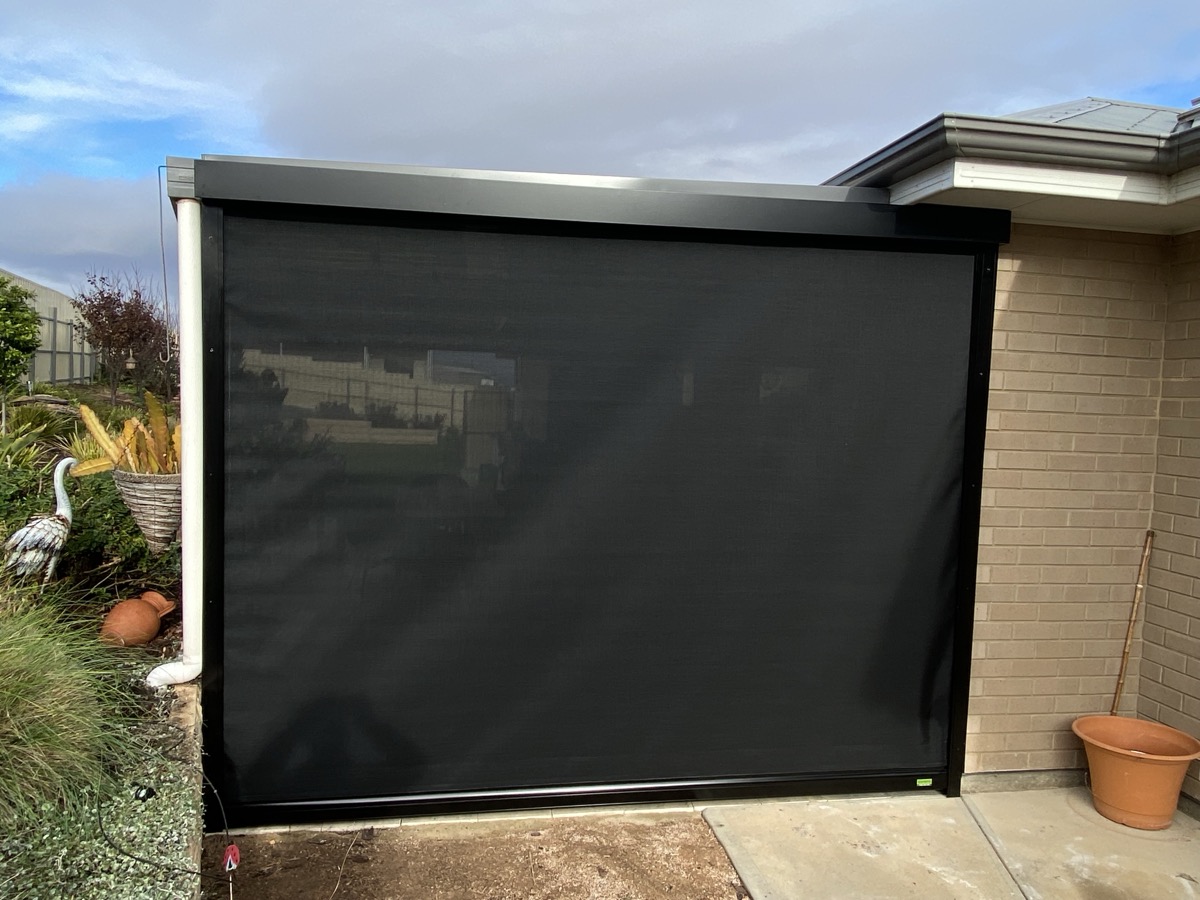 Black outdoor blind limestone house